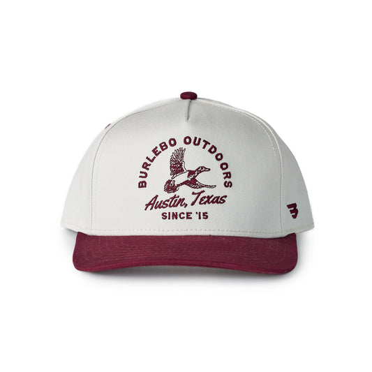 Cap with 'Burlesco Outdoors Austin, Texas Since '15' text and logo on a white background