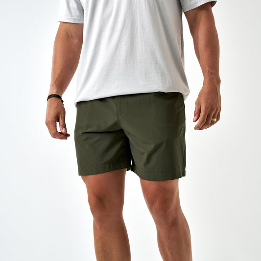 Person wearing green shorts and a white t-shirt on a white background