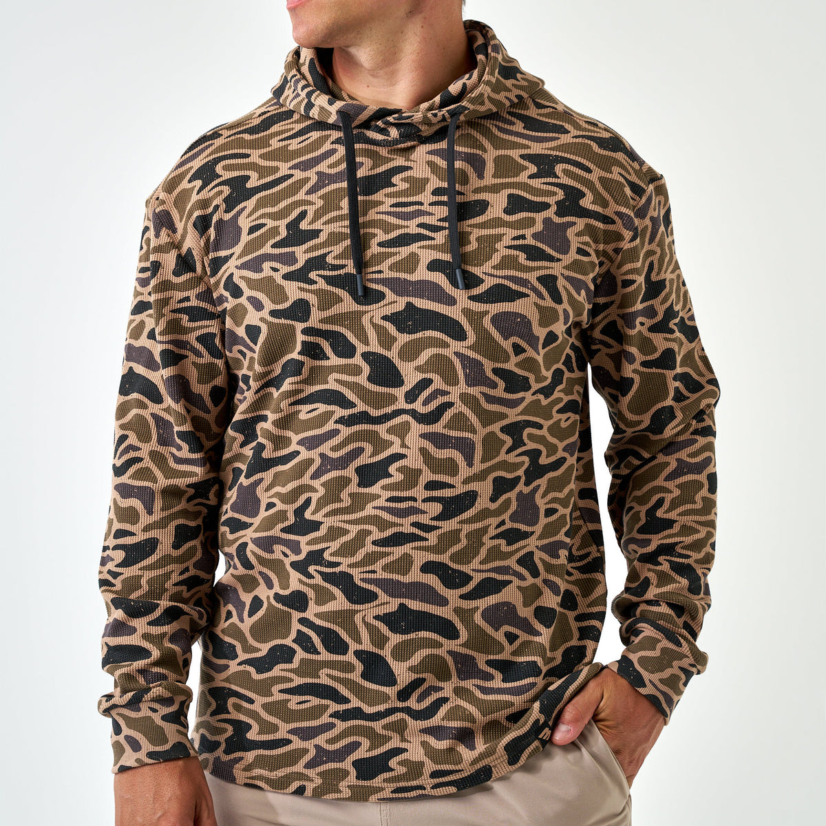 Man wearing the Gauge Camo Thermal Hoodie, front view with black drawstrings