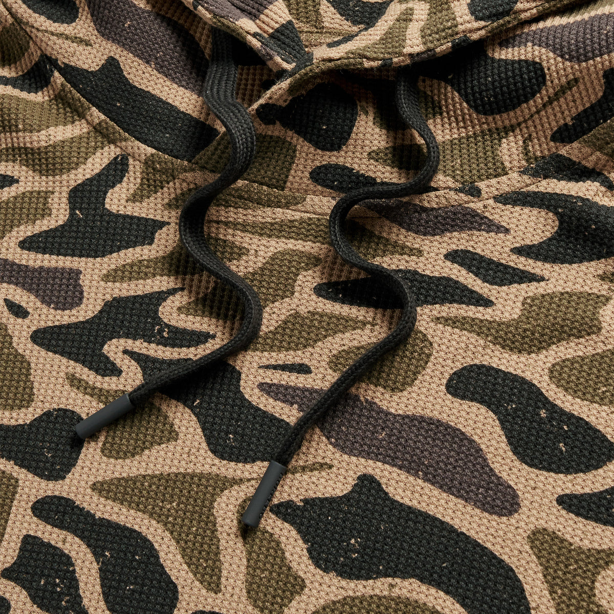 Detail of the Gauge Camo Thermal Hoodie black drawstrings on the waffle knit camo