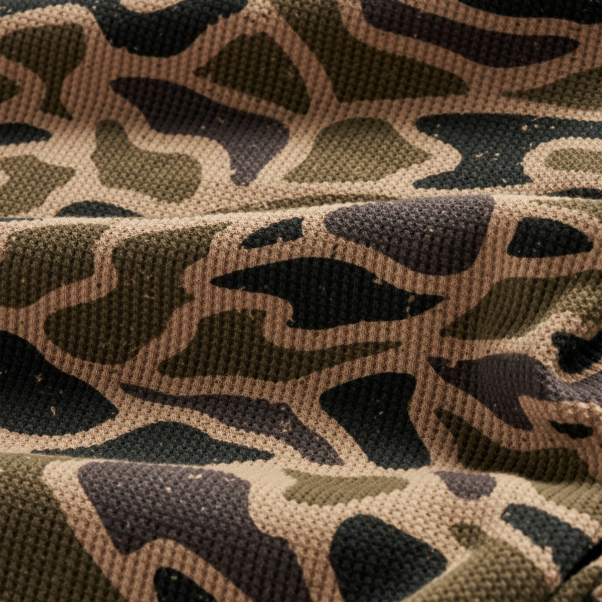Detail of the Gauge Camo Thermal Hoodie waffle knit fabric in brown and black camo