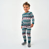 Smiling toddler standing in the BURLEBO Outdoors Christmas Youth Pajama Set with deer, trees, and ducks, and gray socks